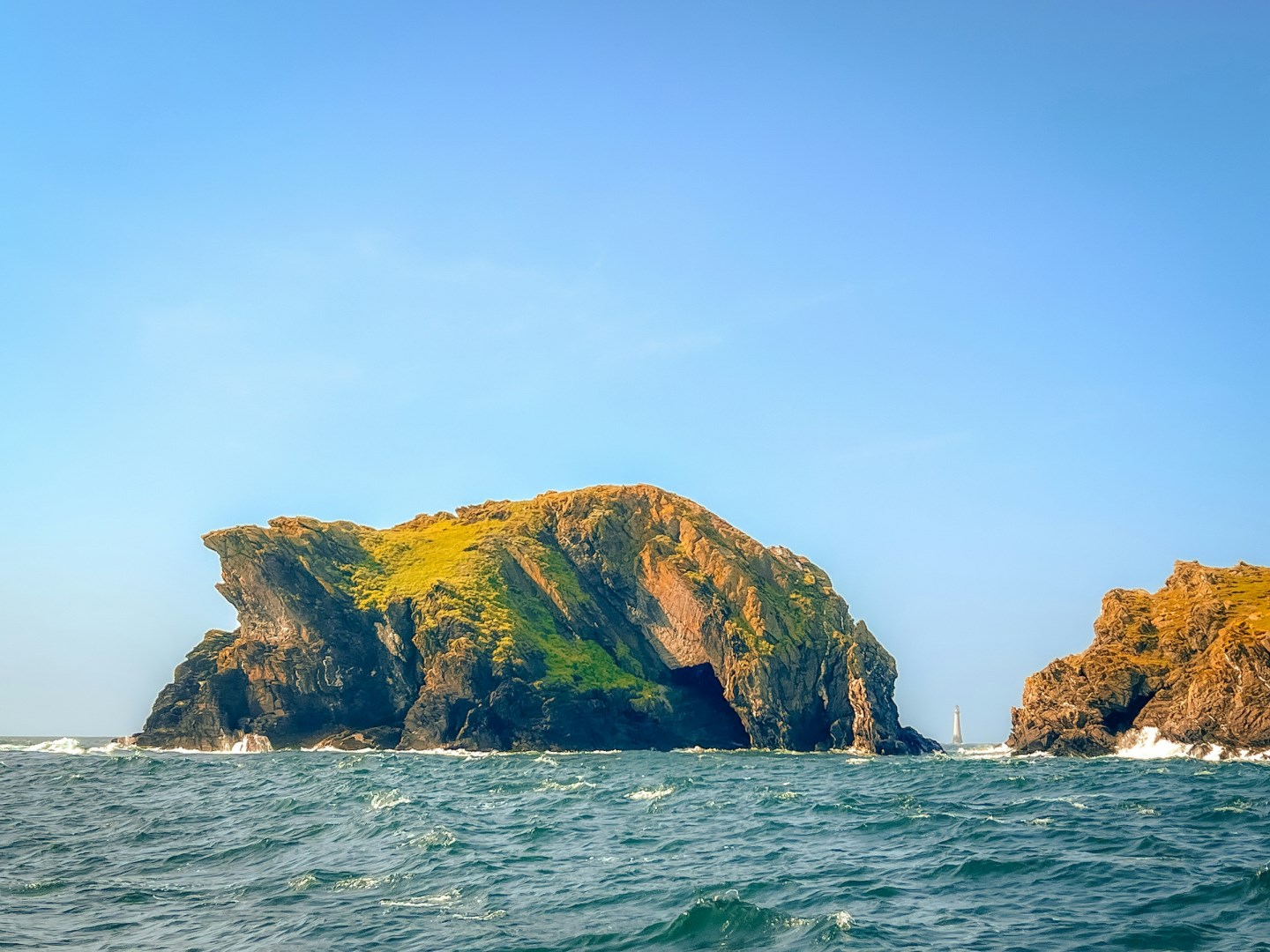 Drinking dragon and the chicken rock lighthouse - Photo Credit: Photo by James Qualtrough 🇮🇲 on Unsplash