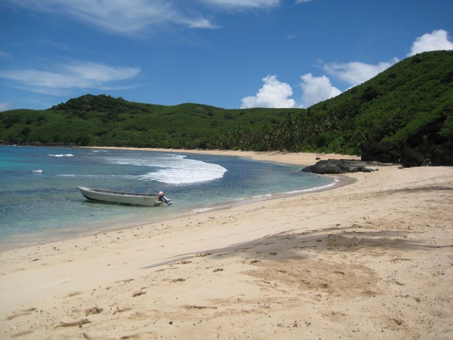 A quiet sandy cove and clear tropical water along the coastline of Waya Island. - Photo Credit: Miguel Sanchez