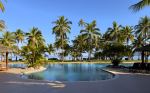 Palm trees surround a lagoon-style pool overlooking the tropical coastline of Malolo Island. - Photo Credit: photobom