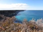 Rugged coastal cliffs overlooking the blue waters of the Great Australian Bight. - Photo Credit: Iurii Ostakhov