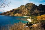 Yalobi Bay curves beneath the rugged mountain peaks of Waya Island in Fiji’s Yasawa Islands. - Photo Credit: Doron