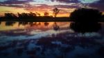 A colorful sunset is reflected in the still waters of Yellow Water Billabong. - Photo Credit: Reesa sc